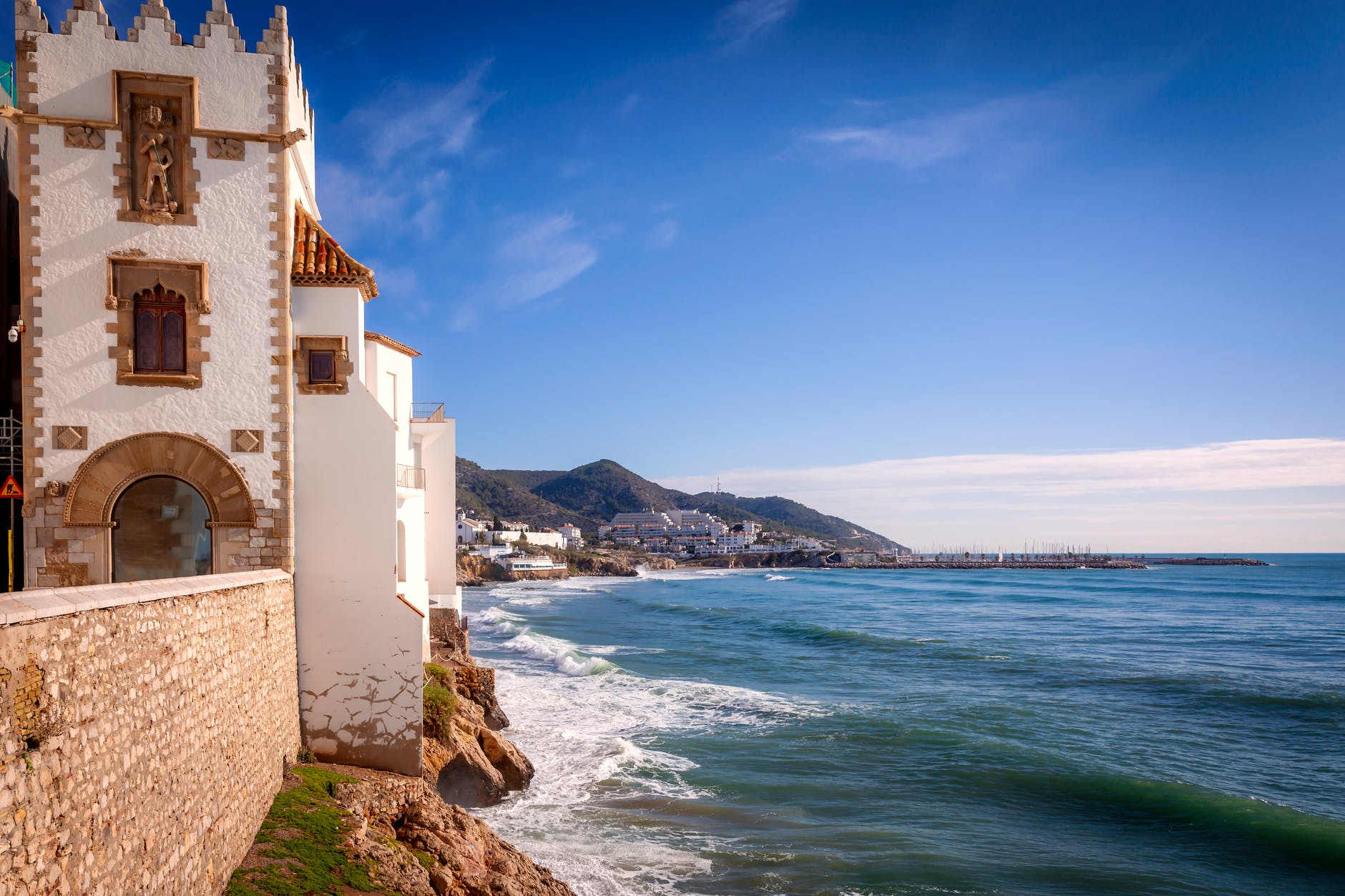 historical building on shore of sea under blue sky
